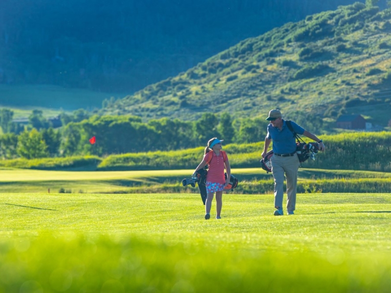 Man and child walking on course